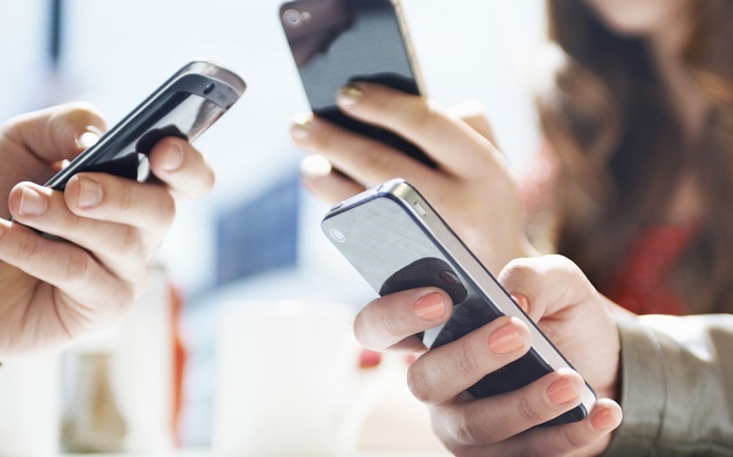 hands texting with mobile phones in cafe